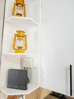 a room with a shelf with a tv on it at Red Peppers in Pretoria