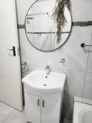 a bathroom with a white sink and a mirror at Red Peppers in Pretoria