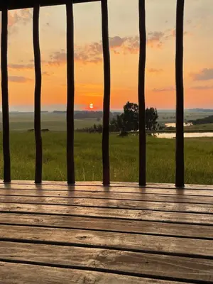 a wooden boardwalk with the sunset in the background at Holbank River Lodge in Ermelo