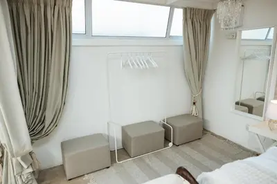 a bedroom with two chairs and a mirror and a bed at 55 Tulbagh events and wedding venue in Kempton Park