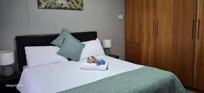 a teddy bear sitting on top of a bed at Christa's Place 899 in Pretoria