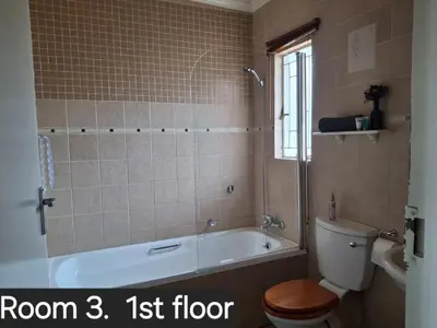 a bathroom with a tub and a toilet and a sink at Christa's Place 899 in Pretoria