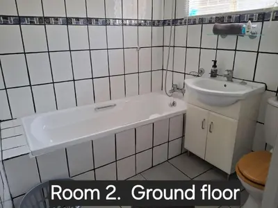 a bathroom with a tub and a sink at Christa's Place 899 in Pretoria