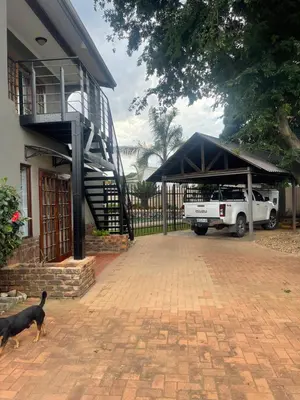 a white truck parked in a garage next to a house at 22 on Mirabel in Kempton Park