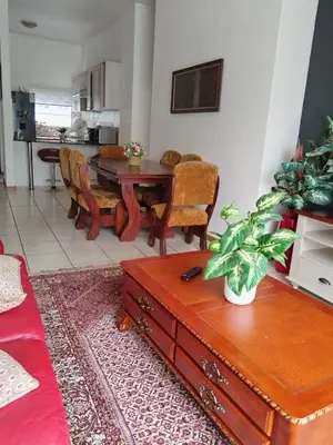 a living room with a table and a dining room at The Classic Menlyn Maine Apartment in Pretoria