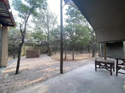 a pavilion with a picnic table in a park at Vlakkieskraal Farmstay - Nyala Tented Camp in Bela-Bela