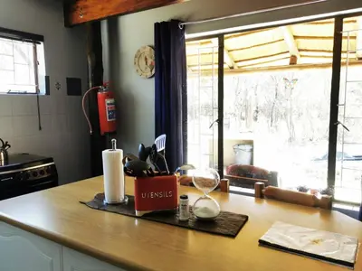 a kitchen counter with a counter top with a window at The Aces - NUDE - SunEden Family Naturist Resort in Pretoria
