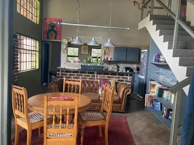 a kitchen and dining room with a table and chairs at The Aces - NUDE - SunEden Family Naturist Resort in Pretoria