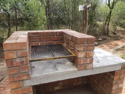 an outdoor brick oven with a grill on top at The Aces - NUDE - SunEden Family Naturist Resort in Pretoria