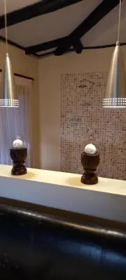 a counter top with two vases on top of it at Bee-Eater Cottage, DaGama Dam in White River