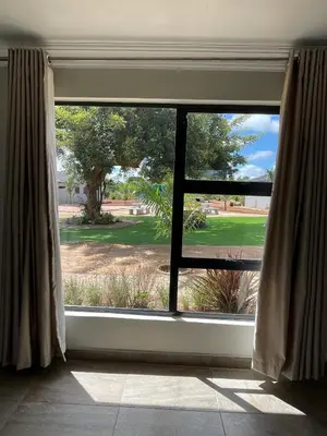 a window in a room with a view of a park at Bluewave Farm Villa in Louis Trichardt