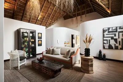 a living room with a couch and a table at Letamo at Qwabi Private Game Reserve by NEWMARK in Bela-Bela