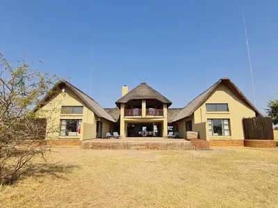 a large house with a large yard at Moshate Lodge Zebula 4 Bedroom Holiday home in Mabula