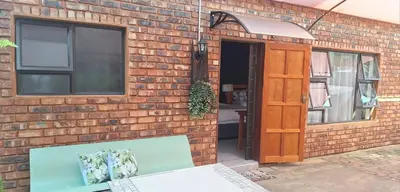 a brick building with a door and a window at Fraai Maraai Self Catering Apartments in Groblersdal