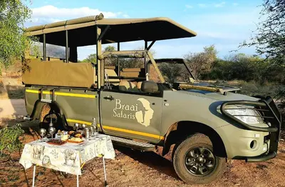 a jeep with a table in front of it at Braai Safaris Lodge in Hoedspruit