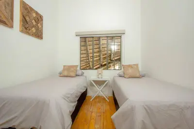 two beds in a room with a window at Eye of Kruger - Spacious holiday home with splash pool and boma in Marloth Park