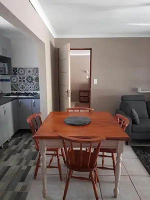 a living room with a wooden table and chairs at Hawkshead Lodge in Alkmaar