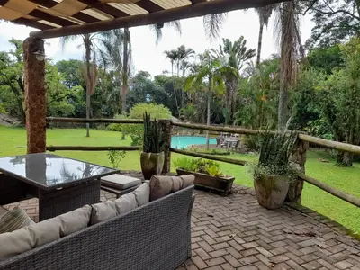 a patio with a table and chairs and a pool at Hawkshead Lodge in Alkmaar