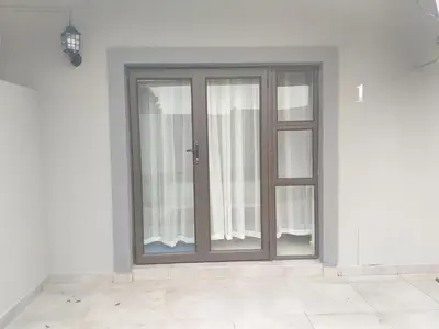 a sliding glass door in a room with white walls at Kanyane @ Graskop in Graskop