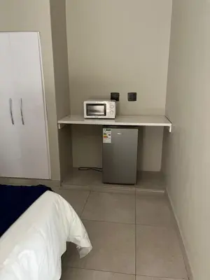 a small room with a microwave on a shelf at Kanyane @ Graskop in Graskop
