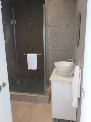 a bathroom with a sink and a glass shower at Kanyane @ Graskop in Graskop