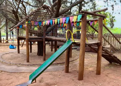a playground with a slide in a park at Olifants River Lodge by Dream Resorts in Middelburg