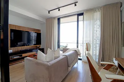 a living room with a couch and a television at Ellipse Apartment in Midrand