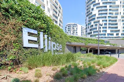 a sign for a building with ivy on it at Ellipse Apartment in Midrand