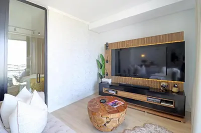 a living room with a large flat screen tv at Ellipse Apartment in Midrand