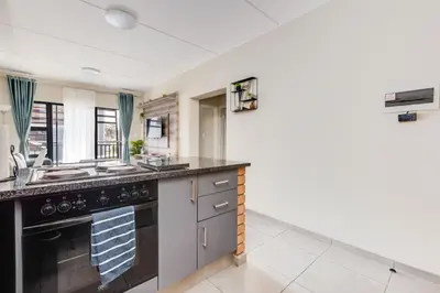 a kitchen with a sink and a stove at The Resting Nest Havilla in Midrand