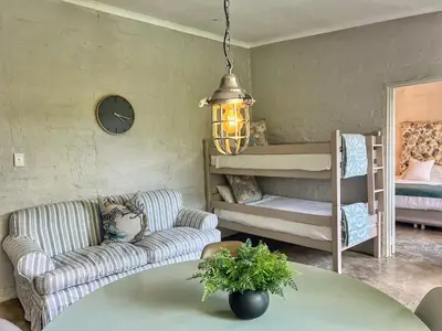 a living room with a couch and a table at Chocolate Orchid in White River