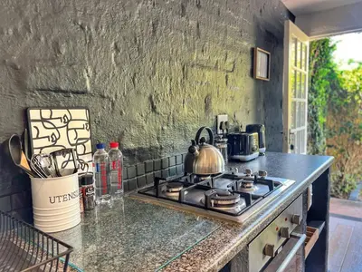 a kitchen with a stove with a tea kettle on it at Chocolate Orchid in White River