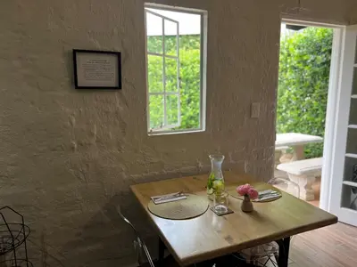 a wooden table in a room with a window at Chocolate Orchid in White River