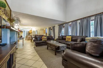 a living room with leather couches and a table at Kruger Park Lodge Unit No. 221 in Hazyview