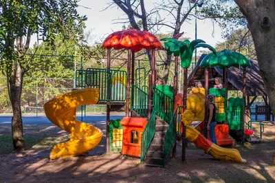 a playground with a slide in a park at Kruger Park Lodge Unit No. 221 in Hazyview