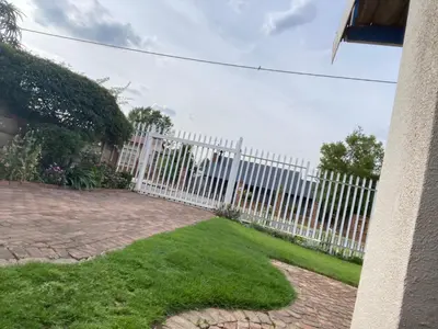 a white picket fence in a yard at Birch stay in Kempton Park
