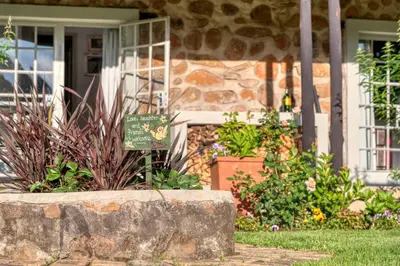 a house with a sign in the front yard at Trout Escape Farm in Dullstroom