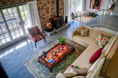 a living room with a couch and a coffee table at Trout Escape Farm in Dullstroom