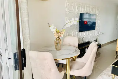 a dining room table with chairs and a vase of flowers at The penthouse in Hartbeespoort