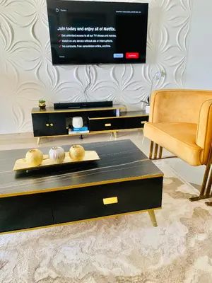 a living room with a black coffee table and a chair at The penthouse in Hartbeespoort