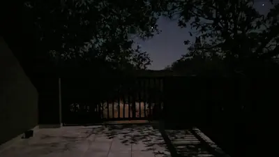 a dark room with a fence and trees at night at Greater Kruger View - Luxury Bush Villa in Marloth Park