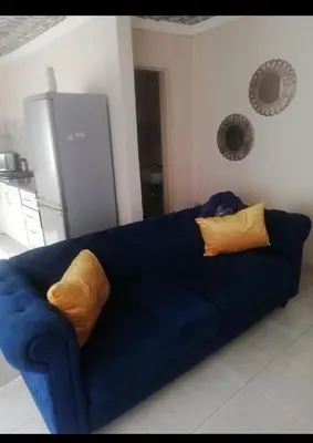 a blue couch with two pillows in a kitchen at Comfort place in Pretoria