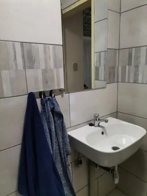 a bathroom with a sink and a mirror and towels at Comfort place in Pretoria