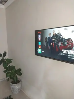 a flat screen tv hanging on a wall at Comfort place in Pretoria