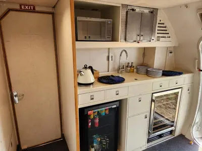 a kitchen in an rv with a sink and a refrigerator at AEROTEL VIP in Hoedspruit