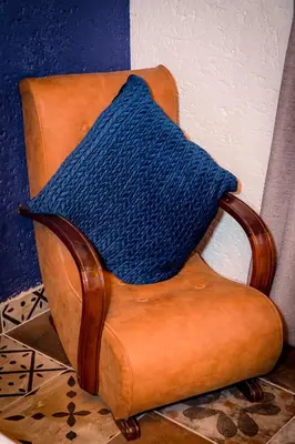 a blue blanket sitting on top of a chair at Koraalboom at Benlize in Hartbeespoort