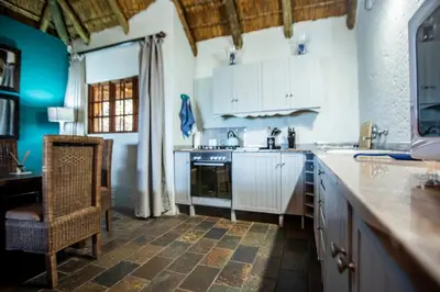 a kitchen with a sink and a stove top oven at Koraalboom at Benlize in Hartbeespoort