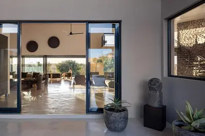 a living room with sliding glass doors at Maya Lodge in Hectorspruit