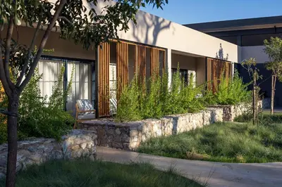 a house with a stone retaining wall at Maya Lodge in Hectorspruit