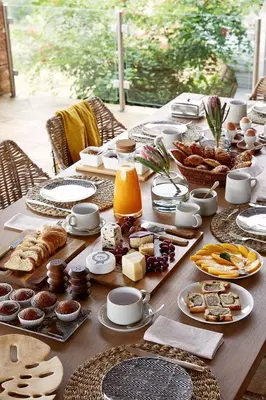 a long table with food and desserts on it at Matomo Safari Lodge in Welgevonden Game Reserve